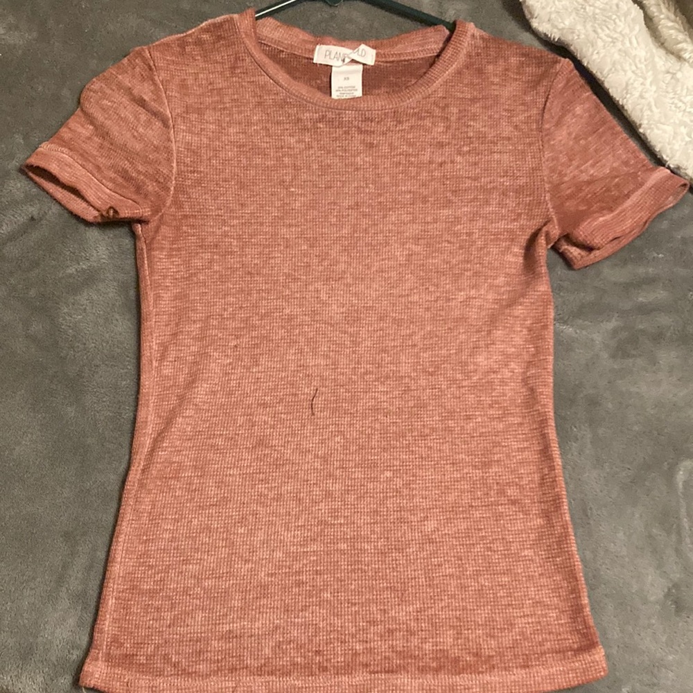 Blush pink shirt, 54% cotton, 46% polyester, size XS but can go up to a size S.